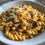 cheesy garlic twisted pasta with cajun ground beef and alfredo velveeta
