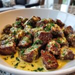 tender steak bites in garlic butter with creamy parmesan sauce